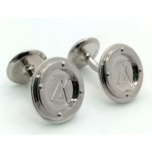 403 - A white metal (untested) LOUIS VUITTON pair of cufflinks in their original designer wallet. REF: 147... 