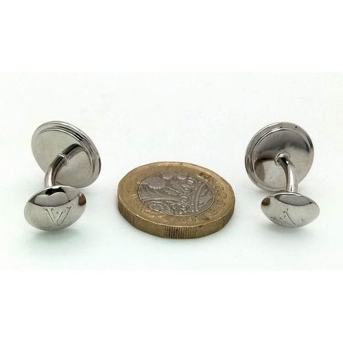 403 - A white metal (untested) LOUIS VUITTON pair of cufflinks in their original designer wallet. REF: 147... 