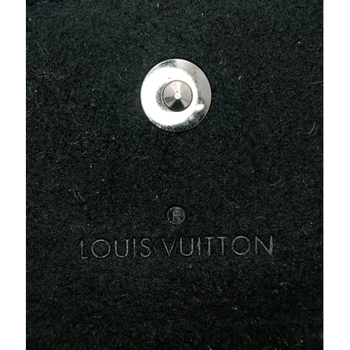 403 - A white metal (untested) LOUIS VUITTON pair of cufflinks in their original designer wallet. REF: 147... 