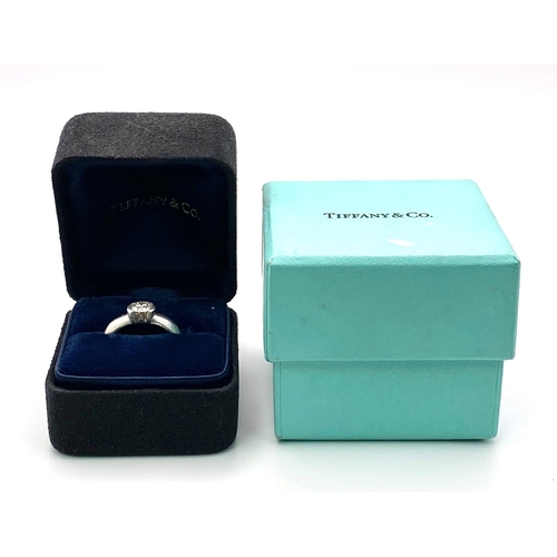 94 - A platinum TIFFANY & CO diamond solitaire ring with the original presentation inner and outer boxes.... 