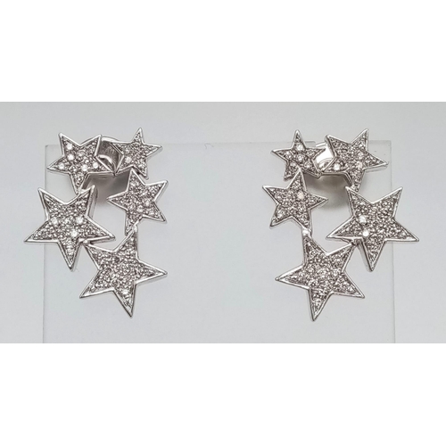 374 - 18kt White Gold, Diamond encrusted Star Earrings. 
Five stars per earring, each star paved with diam... 