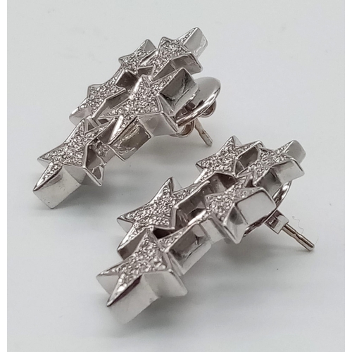 374 - 18kt White Gold, Diamond encrusted Star Earrings. 
Five stars per earring, each star paved with diam... 