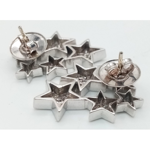 374 - 18kt White Gold, Diamond encrusted Star Earrings. 
Five stars per earring, each star paved with diam... 