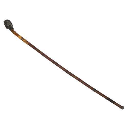 292 - A striking Antique Bronze Headed Sword Stick.
This well-aged bamboo stick with metal bottom stopper ... 