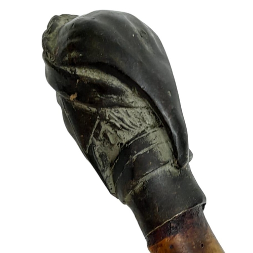 292 - A striking Antique Bronze Headed Sword Stick.
This well-aged bamboo stick with metal bottom stopper ... 