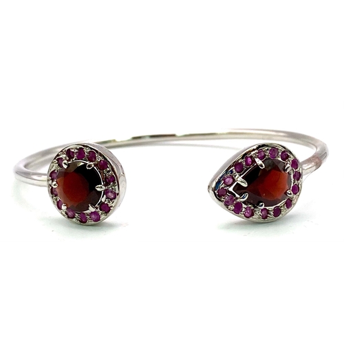 1766 - A Garnet and Ruby Cuff Bangle. Set in 925 Sterling silver. Garnet - 4.80ctw. 13.603g total weight. C... 