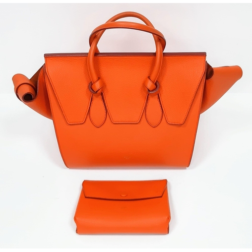 103 - Celine Orange Tie Bag.
Grained leather exterior, vibrant orange colouring. Made in Italy, it has a s... 