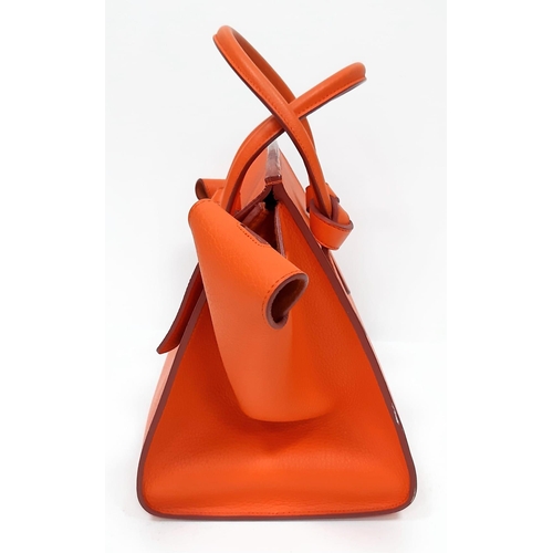 103 - Celine Orange Tie Bag.
Grained leather exterior, vibrant orange colouring. Made in Italy, it has a s... 