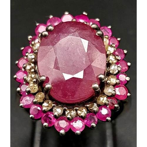 1767 - An 11.40ct Ruby Gemstone Ring with a 0.50ct Diamond Halo. Set in 925 Silver. Size M/N. Comes with a ... 