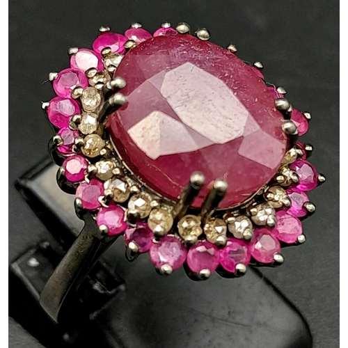 1767 - An 11.40ct Ruby Gemstone Ring with a 0.50ct Diamond Halo. Set in 925 Silver. Size M/N. Comes with a ... 