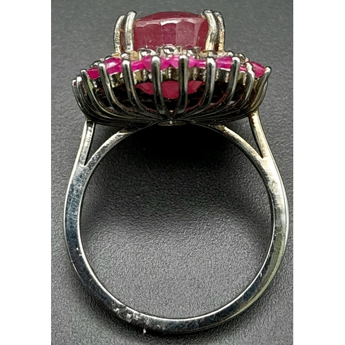 1767 - An 11.40ct Ruby Gemstone Ring with a 0.50ct Diamond Halo. Set in 925 Silver. Size M/N. Comes with a ... 