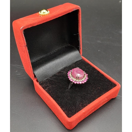 1767 - An 11.40ct Ruby Gemstone Ring with a 0.50ct Diamond Halo. Set in 925 Silver. Size M/N. Comes with a ... 