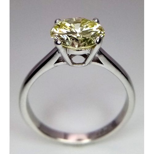 144 - An 18K White Gold and 2.47ct VVS Yellow Diamond Ring. A brilliant round cut dancing centrepiece - No... 