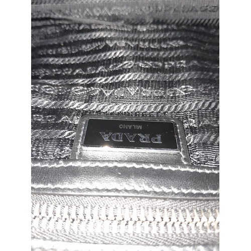 206 - Prada Top Zip Casual Bag. 
Quality leather exterior with Prada Milano detail on front. Comes with a ... 