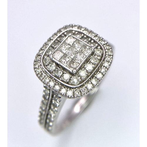 410 - An 18 K white gold ring with a cluster of diamonds on top and more diamonds on the shoulders. Total ... 