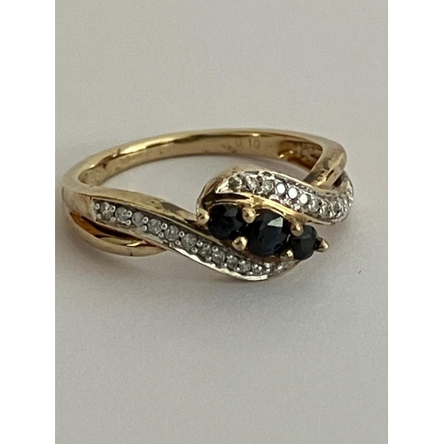 56 - 9 carat GOLD, DIAMOND and SAPPHIRE RING, Crossover design with attractive split shoulder detail. Spa... 