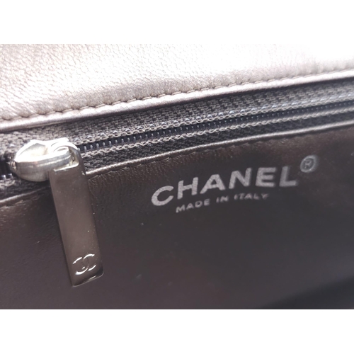75 - Chanel Flap Bag with Handle.
Quality Lambskin leather, Diamond stitching with Silver tone hardware. ... 