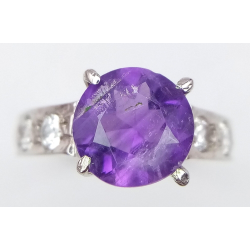 1781 - An Amethyst and White Stone 925 Silver Ring. Amethyst -3ct. 4g total weight. Size M. Comes with a pr... 