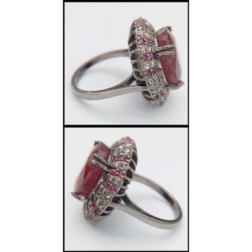 1773 - An 11.75ct Oval Ruby Ring with 0.80ctw of Ruby and 1.3ctw of diamond accents. Set in 925 silver. Siz... 