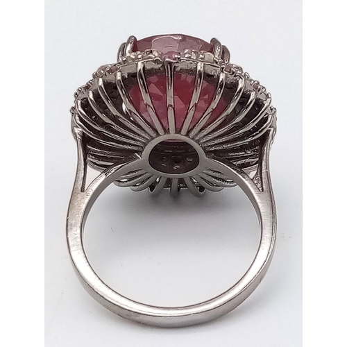 1773 - An 11.75ct Oval Ruby Ring with 0.80ctw of Ruby and 1.3ctw of diamond accents. Set in 925 silver. Siz... 