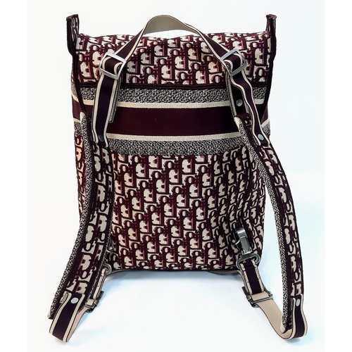 37 - A Christian Dior Burgundy Monogram Backpack. Canvas exterior, with silver toned hardware, flat handl... 