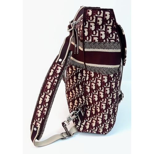 37 - A Christian Dior Burgundy Monogram Backpack. Canvas exterior, with silver toned hardware, flat handl... 