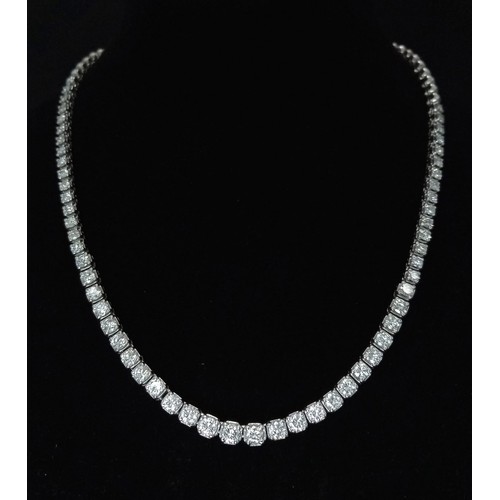 122 - An 18K White Gold with approx 6ct Diamond Tennis Necklace. 55 graduating round cut diamonds create a... 