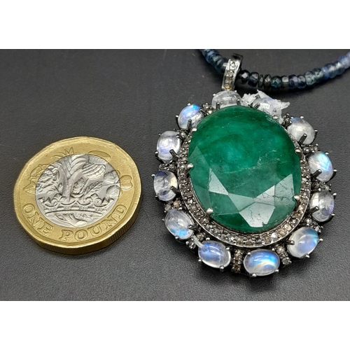 1428 - A 29.50ct Emerald Pendant with 6.60ctw Moonstone and 1.15ctw Diamond Surround, on an Emerald, Ruby a... 