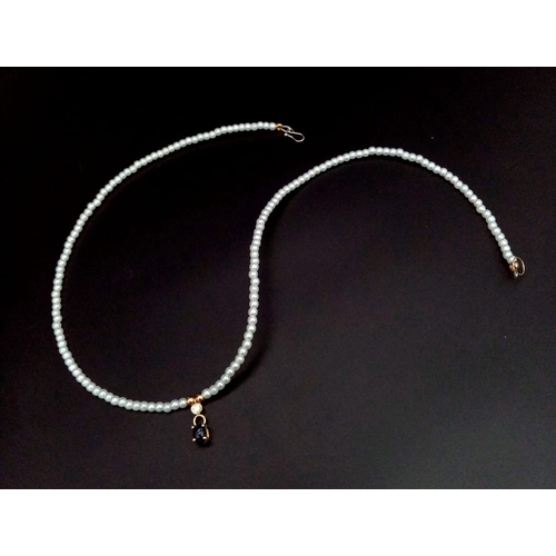 1071 - A Cultured Seed Pearl with Hanging Sapphire and Diamond Decoration. 40cm length. 0.12ct diamond. 14k... 