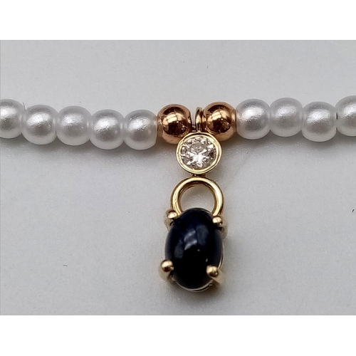 1071 - A Cultured Seed Pearl with Hanging Sapphire and Diamond Decoration. 40cm length. 0.12ct diamond. 14k... 