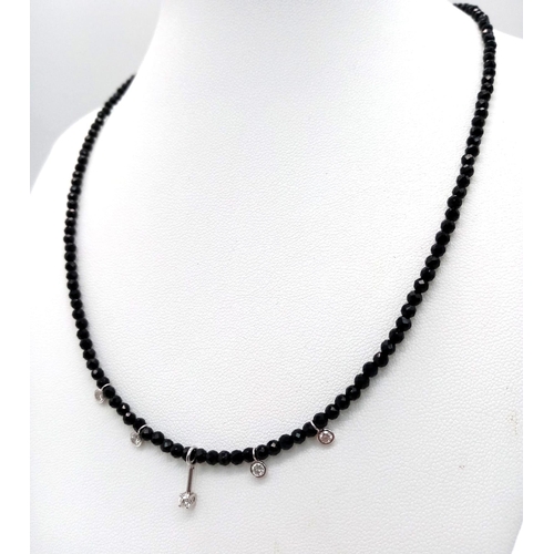 1403 - A Black Spinel Small Bead Necklace with Five Stone White Diamond Decoration. 0.5ctw. 14k gold clasp.