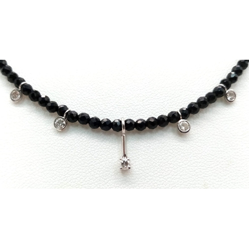 1403 - A Black Spinel Small Bead Necklace with Five Stone White Diamond Decoration. 0.5ctw. 14k gold clasp.