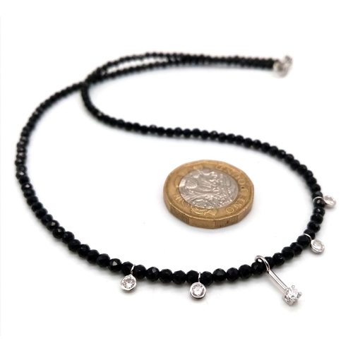 1403 - A Black Spinel Small Bead Necklace with Five Stone White Diamond Decoration. 0.5ctw. 14k gold clasp.