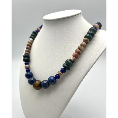 1610 - A Tigers Eye, Jade and Lapis Lazuli Necklace. A mixture of rondelle and round beads. Largest central... 