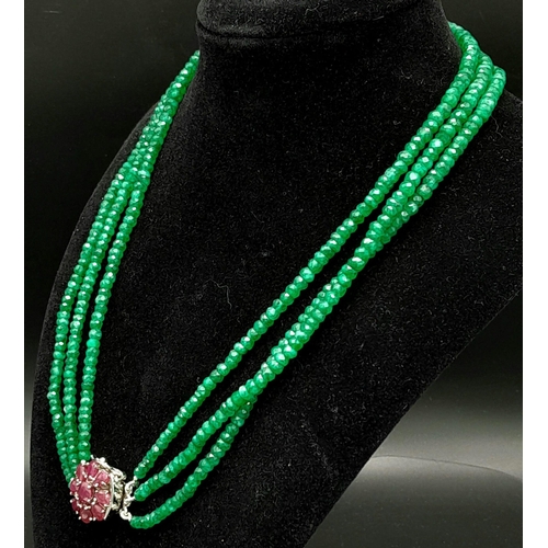 1617 - A Three Row Emerald Necklace with a Ruby and 925 Silver Clasp. 47.5cm in length, 250ctw emeralds, 51... 