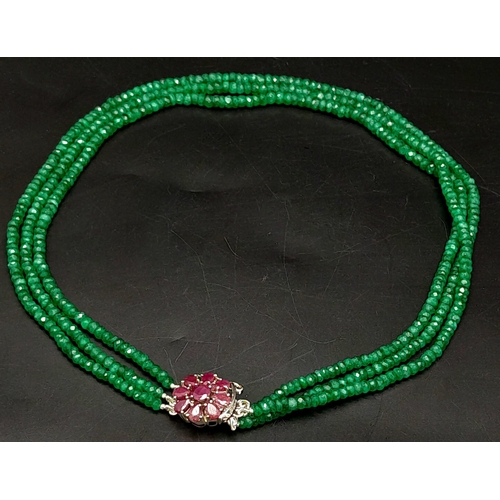 1617 - A Three Row Emerald Necklace with a Ruby and 925 Silver Clasp. 47.5cm in length, 250ctw emeralds, 51... 