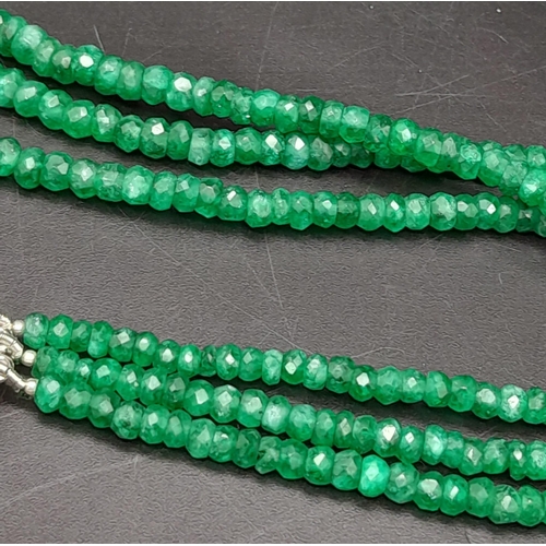 1617 - A Three Row Emerald Necklace with a Ruby and 925 Silver Clasp. 47.5cm in length, 250ctw emeralds, 51... 