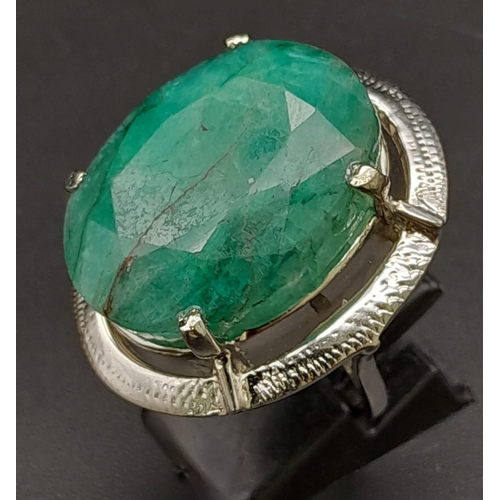 1342 - A 50ct Brazilian Oval Cut Emerald Ring. Set in 925 Sterling Silver. Size P. Comes with a presentatio... 