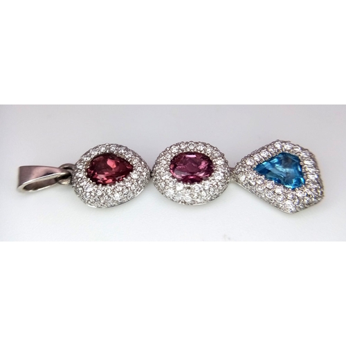 1533 - An 18K White Gold (tested) Ruby, Diamond and Topaz Drop Pendant. Three gemstones with diamond encrus... 