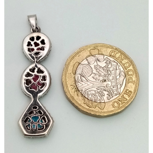 1533 - An 18K White Gold (tested) Ruby, Diamond and Topaz Drop Pendant. Three gemstones with diamond encrus... 