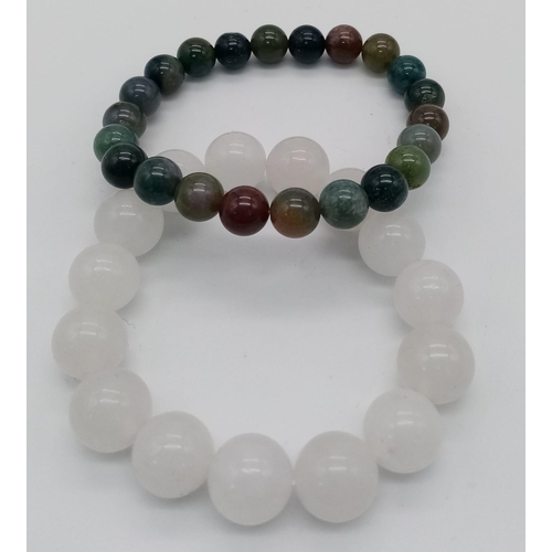 1546 - Two natural stone beaded stretch bracelets.
Both measure 7cm in diameter.