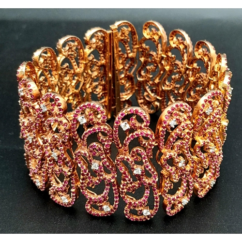 1547 - An 18K Rose Gold Ruby and Diamond Statement Bracelet. Interlocking ruby encrusted seahorse links wit... 