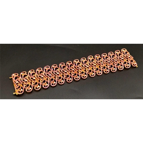 1547 - An 18K Rose Gold Ruby and Diamond Statement Bracelet. Interlocking ruby encrusted seahorse links wit... 