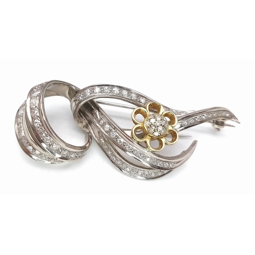 1554 - Diamond encrusted 18kt White & Yellow Gold Brooch.
Beautifully woven White Gold design, adorned with... 