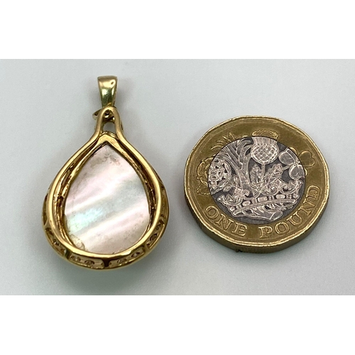 1329 - An 18K Yellow Gold, Diamond and Mother of Pearl Pendant. 
Teardrop Mother of Pearl cabochon with dia... 