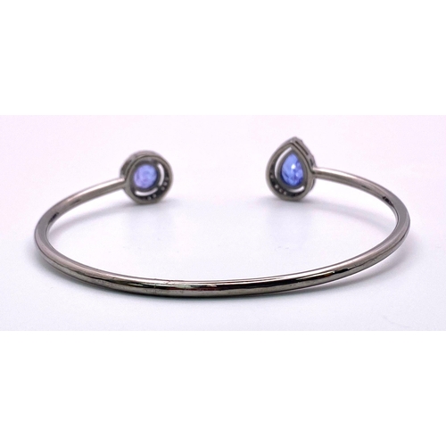 1426 - A Tanzanite and Diamond 925 Silver Cuff Bangle. Tanzanite - 4ctw. Diamonds - 0.50ctw. 11.83g total w... 