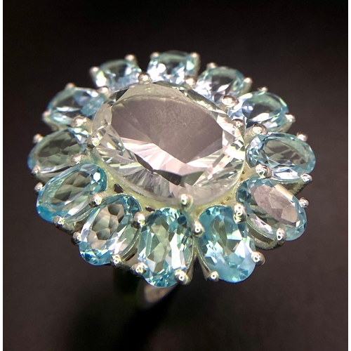 1469 - An Eye-Catching Blue Topaz Gemstone Cocktail Ring with White Topaz Centre. Set in 925 Silver. Size Q... 