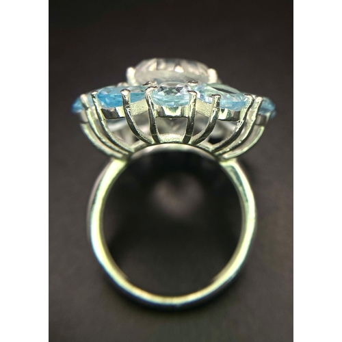 1469 - An Eye-Catching Blue Topaz Gemstone Cocktail Ring with White Topaz Centre. Set in 925 Silver. Size Q... 