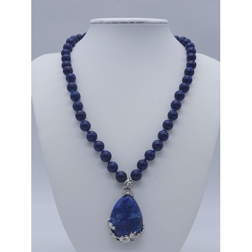 1575 - A Lapis Lazuli Suite Comprising of Necklace with Drop Pendant - 42cm and 4cm. Decorative oval lapis ... 