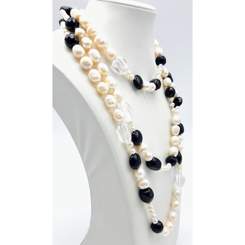 1624 - A Rope Length Cultured Pearl and Onyx Necklace. 136cm length.